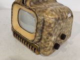 a small television sitting on top of a white table