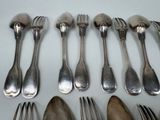 a lot of silver spoons and forks on the table