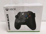 a close up of a box with a game controller inside of it