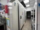 many refrigerators in this kitchen that are lined up