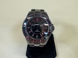 a close up of a watch on a stand on a table