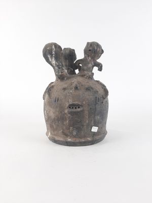 a black vase with two birds on it