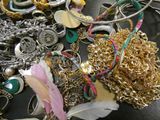 a pile of gold and silver jewelry on a table