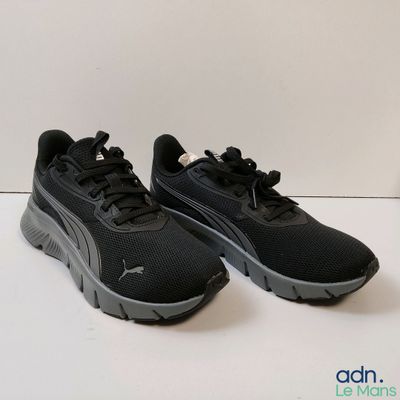 the puma sneakers are black and grey on a white background