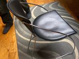 a black chair sitting on a rug in a living room