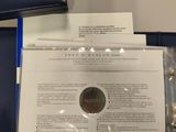 a close up of a folder with a coin on top of it