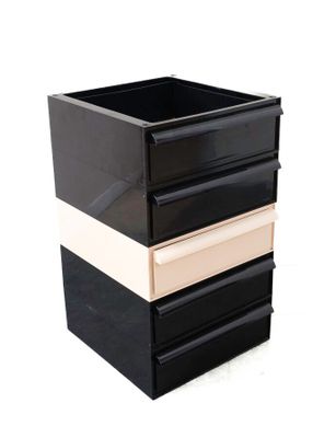 a black and white box with three drawers in it