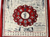 a close up of a red and white banda with a picture of a person on it
