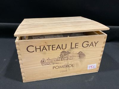 an old wooden box with a bottle of wine inside of it
