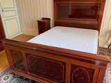 a bed with a wooden headboard and foot board in a room