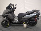 an image of a motor scooter parked on a checkered floor