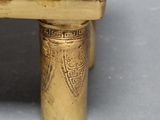 brass figurine of an elephant on a pedestal with a gold base
