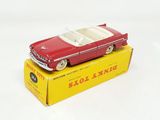 a red toy car sitting on top of a yellow box