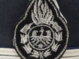 an air force officer ' s cap with a silver and black emblem