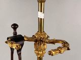 an image of a gold plated sword on a stand with a wooden handle