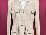 an image of a beige jacket on a mannequin stand