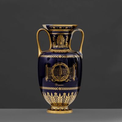 an image of a blue and gold vase on a table