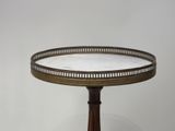 a round table with a glass top and a wooden base