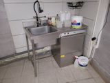 a kitchen with a sink and a dishwasher in it