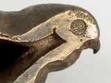 a close up of a metal object on a white surface