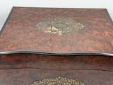 a small wooden box with a decorative design on it