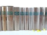 books are lined up in a row on a white surface