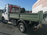 a green truck parked in front of a building