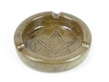 a brown ashtray with a masonic symbol on it