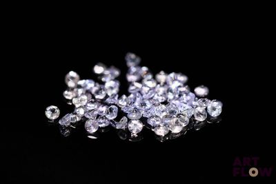 a close up of a bunch of diamonds on a black surface
