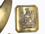a gold plate with a picture of a bird on it