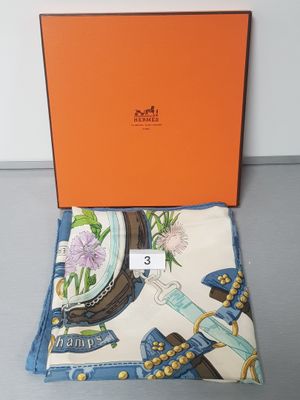 the box is open on the table with a scarf and other items