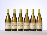 six bottles of wine are lined up in a row on a table