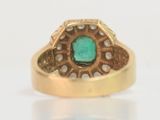 an image of a gold ring with a green stone in the center