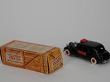 a black toy car next to a box of honey