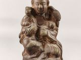 an image of a statue of a man holding a baby