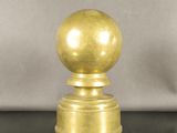 a golden ball sitting on top of a black table