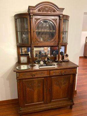 a wooden cabinet with a clock on top of it