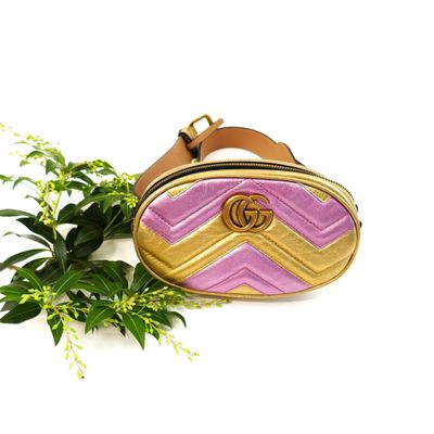 a close up of a purse on a white surface with flowers