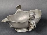 an antique silver plated bowl with a boy in the center