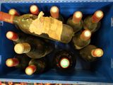many bottles of wine in a blue crate on a table
