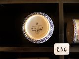 two cups sitting on a shelf with a price tag