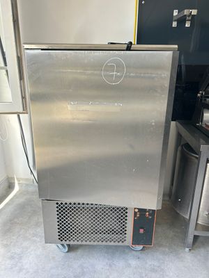 a stainless steel refrigerator sitting in a kitchen next to a stove