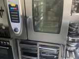 a commercial oven in a kitchen with a lot of pots and pans