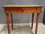 an old wooden table with a drawer on top of it