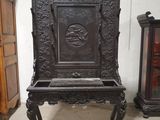 a very old wooden chair in the middle of a room
