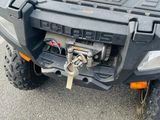 an image of a red four wheeler atv parked in a parking lot