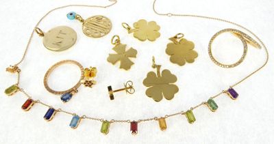 many different necklaces and bracelets that are on a table
