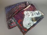 a pile of papers that have been folded up on a table