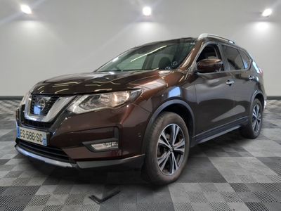the front of a brown nissan suv parked on a checkered floor