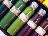many different colored bottles of paint in a black box